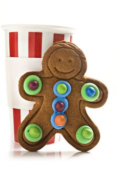 Red and white coffee mug with colorful gingerbread man