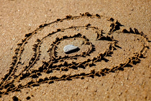 Hearts drawn out on a sandy beach