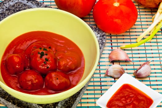 Bowl with meatballs and tomato sauce