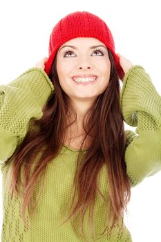 young happy brunette woman in wool sweater and cap, isolated on white