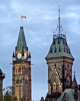 The Canadian Parliament Centre and East Blocks with the Maple Leaf flag in Ottawa, Ontario, Canada.