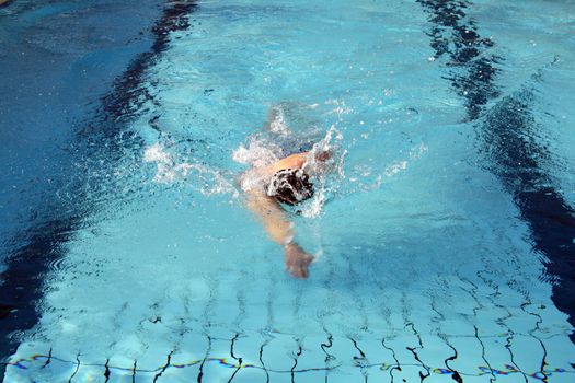 man swims in swimming pool