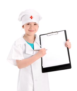 Smiling little girl wearing as a nurse on white uniform pointing with pen on a blank medical report. Isolated on white background.
