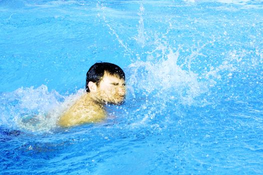 man swims in swimming pool