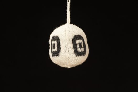 Knitted ball - on black background