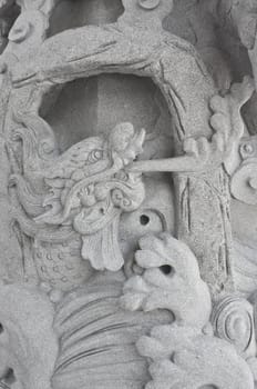 stone carving, the carving is a beautiful dragon.