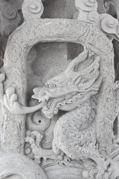 stone carving, the carving is a beautiful dragon.