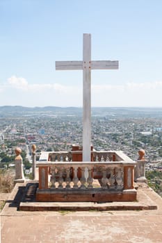 Cross on Loma de la Cruz or Hill of the Cross in Holguin, capital city of the province of Holguin, Cuba, which can be seen in the background.