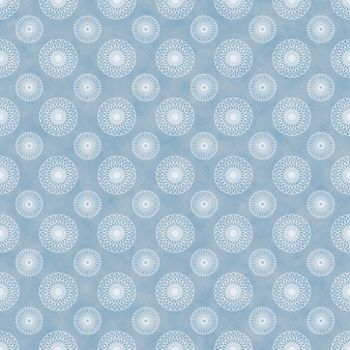 White kaleidoscope spirals on faded blue denim chambray fabric