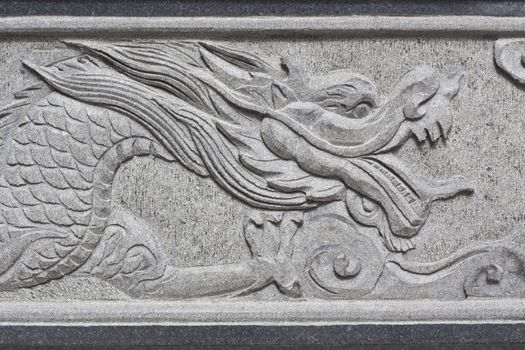 stone carving, the carving is a beautiful dragon.