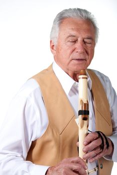 senior musician with native american flute and leather vest