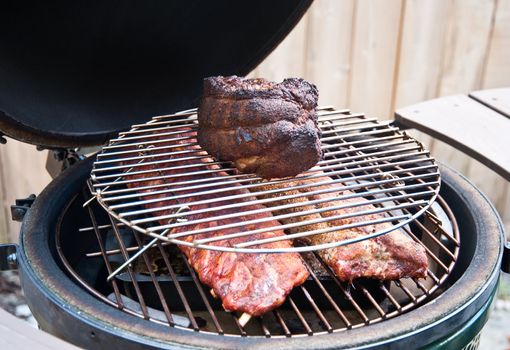 Pork shoulder and ribs on a grill