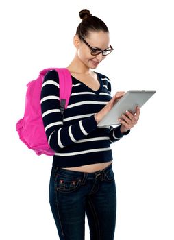 Attractive teenager working on tablet pc against white background