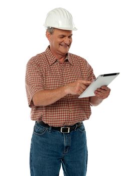 Aged architect working on tablet pc isolated over white background