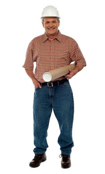 Smiling architect posing with blueprints, full length portrait