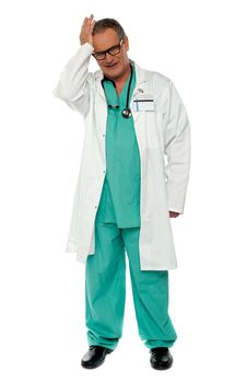 Full length shot of unhappy doctor in uniform isolated over white background