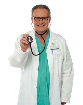 Smiling doctor checking your heartbeat with help of stethoscope