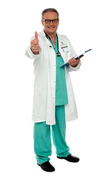 Thumbs up from senior medical professional, full length portrait