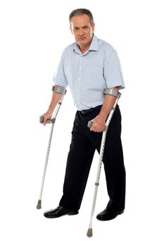 Old handicapped man with a walker  standing against white background