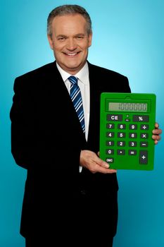 Senior manager showing big green calculator isolated against gradient background