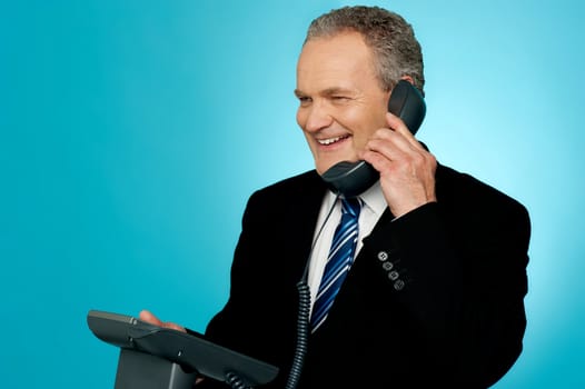 Senior manager discussing deal with client over a phone call