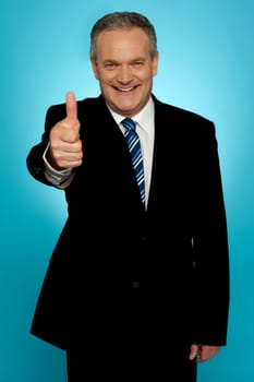 Isolated corporate man showing thumbs up to camera