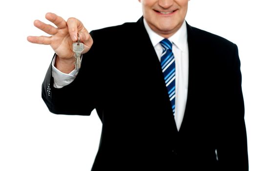 Cropped image of businessman holding keys isolated over white background