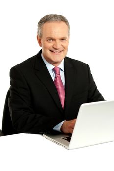 Confident businessman working on laptop isolated over white background