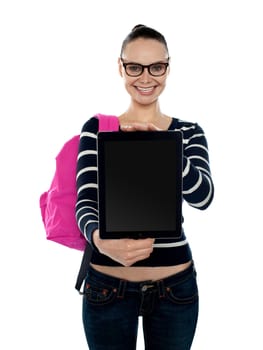 Cheerful college girl showing blank touch screen device to camera. Newly launched product
