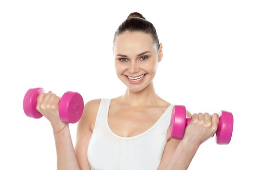 Attractive athlete exercising with dumbbells isolated against white