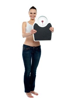 Full frame woman holding a scale against white background