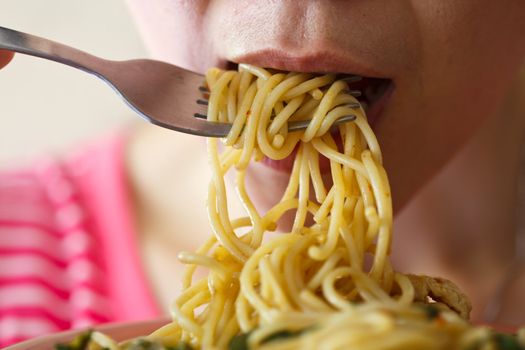 Beautiful young women are eating spaghetti in spicy