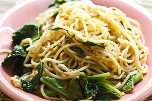 Stir in spaghetti spicy flavors on the plate pink