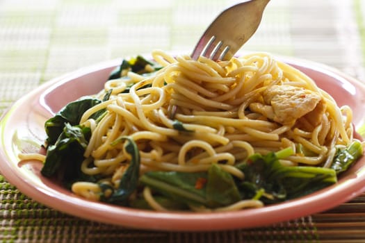 Stir in spaghetti spicy flavors on the plate pink