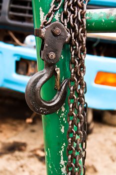 Large metal hook and chains attached to a pulley