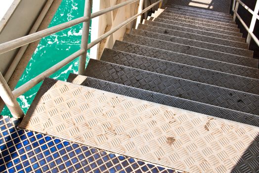 Steel stairs of the ferry. And sailing in the sea.