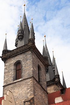 Classical gothic architecture. Red tiling roofs near high ancient towers. Prague,Czech Republic