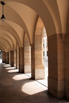 Elegance marble old colonnade with hanging lanterns at midday