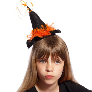 serious girl with small witches hat