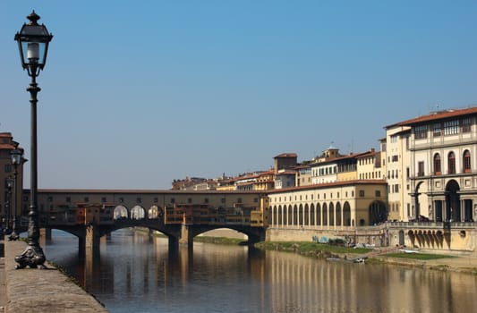 Distant shot of the famous Ponte Vecchio in Florence in a bright sunny day.