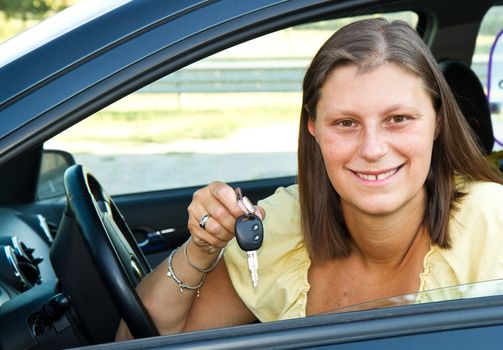 car driver woman smiling showing new car keys 