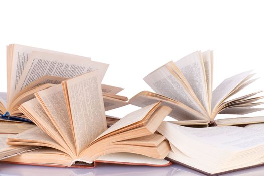 many opened books lying on the table