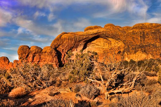 Autumn sunset lights up baby arch in Utah desert with amazing golden glow
