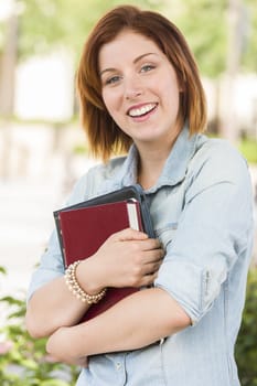 Smiling Young Pretty Female Student Standing Outside with Books.