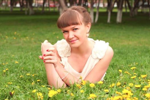 portrait of a woman lying on the grass in the park