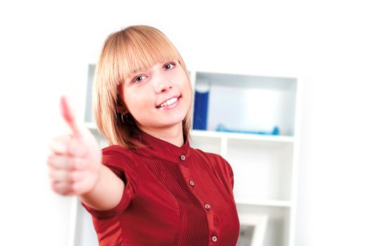 woman in the office shows a thumbs-up
