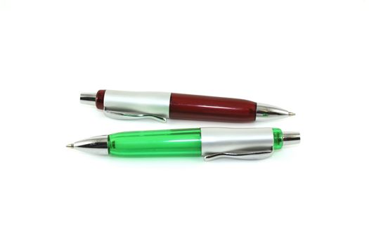 Brown and green pen over white