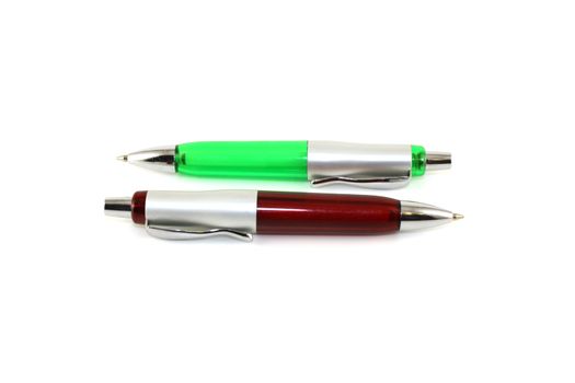 Brown and green pen over white