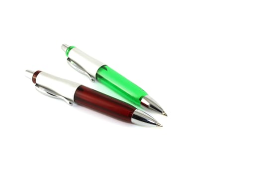 Brown and green pen over white