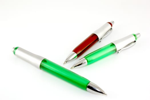 Brown and green pen over white